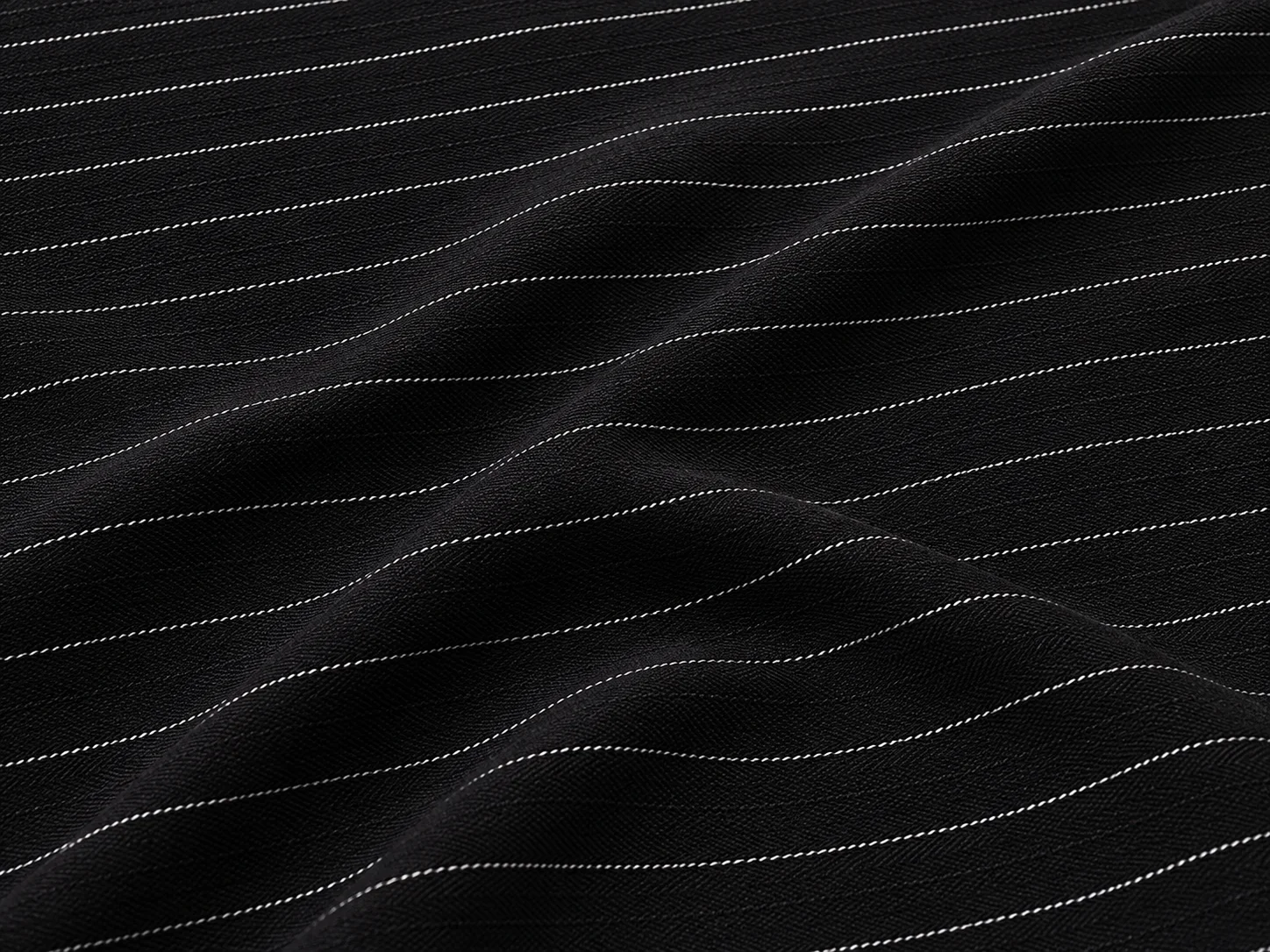 Black Pinstripe Herringbone Suiting Fabric On the bench